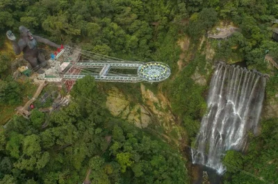 Walk the gulong canyon glass bridge, see waterfalls, and enjoy a private day trip from guangzhou. includes hotel pickup, local guide, and lunch option.