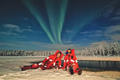 Float in a frozen lake near rovaniemi, hunt for the northern lights, and warm up by a fire with cookies. includes hotel pickup, floating suits, and local guide.