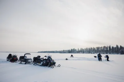 Ride snowmobiles across lapland’s frozen lakes and try traditional ice fishing in rovaniemi. includes local guide, pickup, winter gear, and campfire lunch.