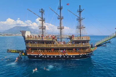 Sail alanya’s coast on a pirate ship with swimming stops at cleopatra beach, caves, and castle views. includes lunch, unlimited drinks, hotel pickup, and local guide.