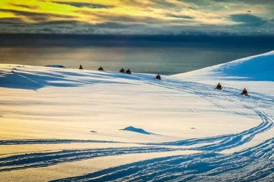 Ride a snowmobile across eyjafjallajökull glacier, see westman islands & volcano views, and learn from a local guide. includes gear, helmet, and face mask.