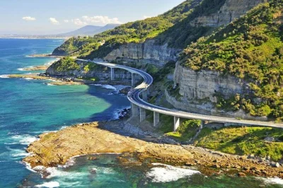 Descubra a costa sul e o interior de sydney em um tour privado de um dia. caminhe pela sea cliff bridge, veja o kiama blowhole, as fitzroy falls e aproveite o traslado do hotel.