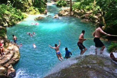 Experience the blue hole near ocho rios with a local guide, cliff jumping, rope swings, and hotel or cruise port pickup. includes bottled water and transport.