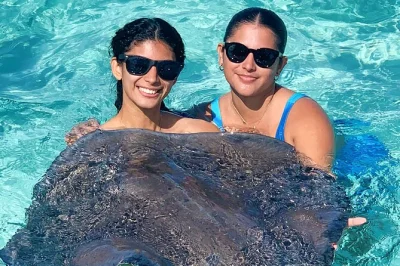 Swim with stingrays at stingray city, snorkel vibrant coral gardens, and relax at starfish point on a private grand cayman boat tour with local crew and lunch.