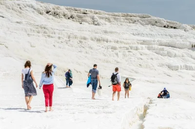 Travel from antalya to pamukkale’s travertine pools and explore ancient hierapolis, with hotel pickup, lunch, and a friendly local guide included.