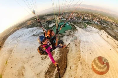 Fly tandem over pamukkale’s iconic white cliffs, spot ancient ruins from the air, and enjoy hotel pickup. experience paragliding with a trusted local pilot.