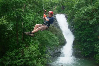 Feel the rush of 18 ziplines over 11 waterfalls near puntarenas, costa rica, with a local guide. includes pickup, canyon rappel, and time to swim in a natural pool.