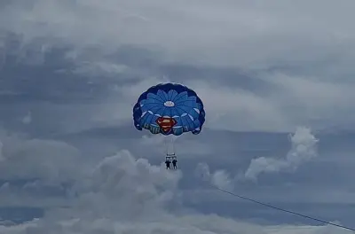 Parasailing at Seven Mile Beach: White sand and parachute views