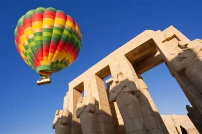 Experience a sunrise hot air balloon ride over luxor, egypt. see temples and the nile from above. includes hotel pickup, expert guides, and live commentary.