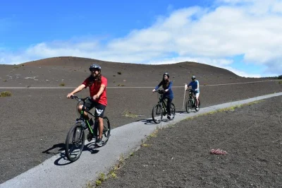 Feel the heat of erupting craters, ride lush trails, and explore thurston lava tube on a self-guided e-bike tour in hawaii volcanoes. includes gear, gps audio, and lunch stop.