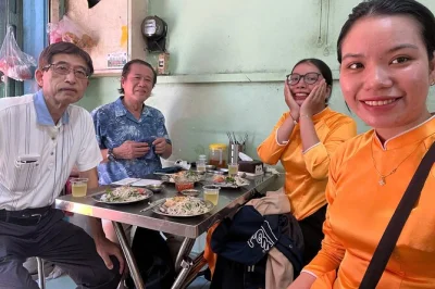 Ride through ho chi minh city by scooter, sampling street food like banh mi and broken rice, with a local guide. includes hotel pickup and drop-off.