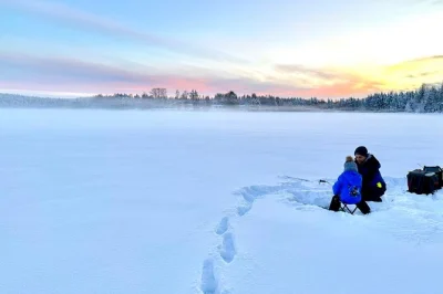 Feel the crunch of snow underfoot and try traditional ice fishing on lake kuoksa near rovaniemi, with a local guide, warm gear, and blueberry juice included.