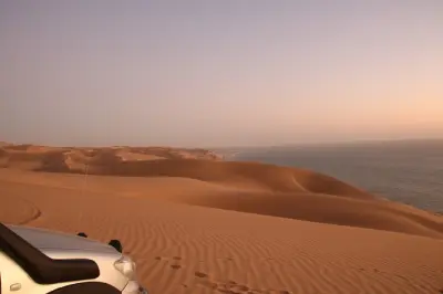 Sandwich Harbour sunset tour: Desert dunes meet ocean