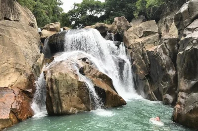 Ride from nha trang to ba ho waterfall by motorcycle. visit local villages, craft makers, and temples. includes lunch, guide, and hotel pickup.