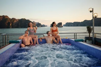 Step onto a ha long bay cruise from hanoi with caves, kayaking, swimming, and a buffet lunch. includes hotel pickup, english guide, and sunset party on deck.