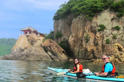Explore tomonoura by sea kayak—visit abuto kannon, tashima island, and taste homeishu sake. guided tour with local lunch and unique seto inland sea views.