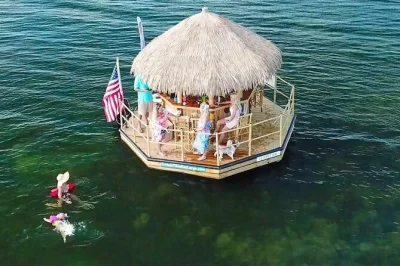 Float through key largo on a tiki bar boat, swim in warm waters, sip drinks, and spot wildlife. includes music, cooler, life jackets, and local guide for a relaxed escape.