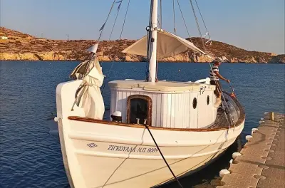 Ios boat tour: Traditional wooden boat with snorkeling and drinks