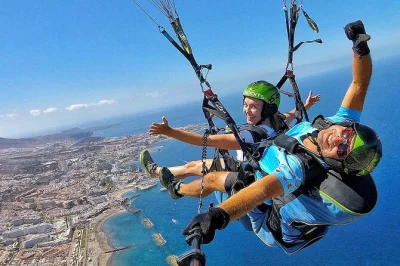 Feel the rush of tandem paragliding in south tenerife with a local guide, soaring from 800m over beaches. includes hotel pickup and all equipment.