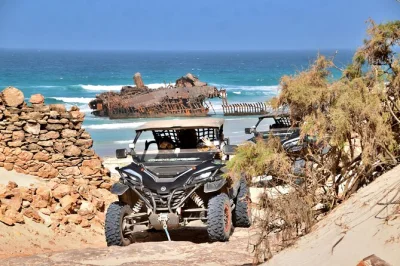 Feel the wind on a boa vista buggy tour, see the cabo santa maria shipwreck, cross viana desert, and enjoy ocean views. includes pickup, helmet, water.