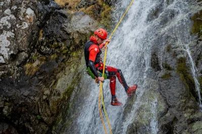 Feel the rush in snowdonia with canyoning—big jumps, fast slides, zip lines, and abseiling down waterfalls. includes all gear, free photos, and cake after.