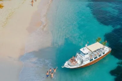 Feel the energy of ibiza on a 12-hour cruise to formentera with paella lunch, open bar, swim stops, and sunset party. includes pickup and local guide.