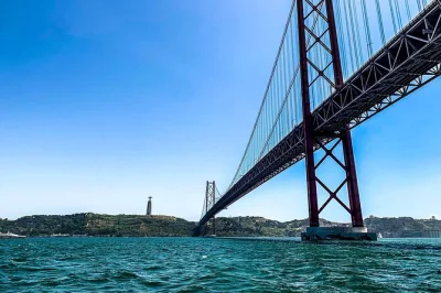 Float past lisbon’s riverside icons on a 2-hour sailing cruise with portuguese wine, local guide, and small group comfort. includes pickup and all fees.
