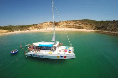 Golden cliffs, hidden caves and a swim stop on a lagos catamaran cruise. paddle boards, waterpark, and live english commentary included. book with easy pickup.