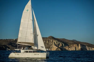 Feel the volcanic spirit of santorini on a day cruise with swimming stops, bbq lunch, open bar and local guide. includes pickup and drop-off from your hotel.