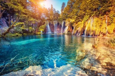 Feel the mist of plitvice lakes, stroll with a guide, and travel from zagreb to split or trogir in comfort. includes pickup, train & boat rides, and all logistics handled.