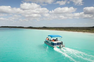 Feel the colors of bacalar’s lagoon on a private boat tour with local guide, swim in clear water, see cenotes & enjoy fresh fruit picnic. includes drinks & kayak time.