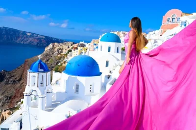 Feel the breeze in a flying dress as a local photographer captures you by santorini’s blue domes. includes dress, edited photos, and assistant for every pose.