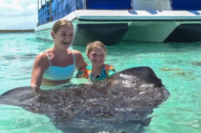 Swim with wild stingrays at stingray city antigua, wade on a shallow sandbank, and enjoy round-trip pickup from your resort or cruise port. rash guard and drinks included.