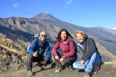 Feel the heat of mount etna on a private trek, explore a lava cave with helmets, and taste local honey and wine at a sicilian farm—includes 4x4 pickup.