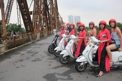 Feel hanoi’s pulse from the back of a vespa with ao dai-clad female riders. explore train street, meet locals, taste egg coffee. includes hotel pickup & lunch.