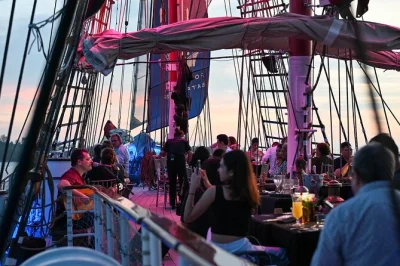 Sail singapore’s harbor at sunset on a tall ship with buffet dinner, free-flow wine & beer, and live entertainment. includes early boarding and a souvenir mug.