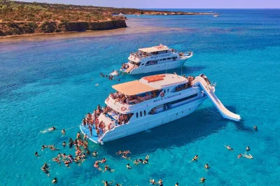 Swim in the blue lagoon near latchi, try the boat’s waterslide, enjoy wine or lemonade, and snorkel with mediterranean fish—includes equipment & local guide.