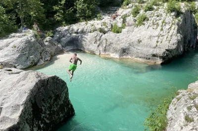 Feel the spray at peričnik waterfall, cross into italy for lake predil, and swim in soča’s emerald waters—ljubljana pickup, local guide, small group comfort.
