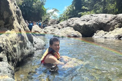 Hear coqui frogs, swim volcanic pools, and taste fresh fruit on this el yunque small group adventure with licensed guide and included transport from san juan.