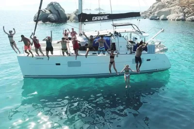 Set sail from santorini on a catamaran cruise, swim in quiet coves, share greek food onboard, and enjoy wine & beer with lunch. includes snorkeling gear and group pickup.