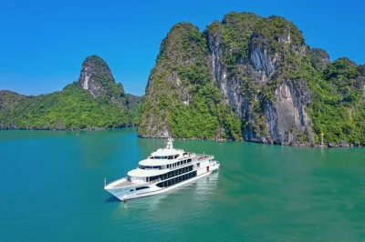 Descubre la magia tranquila de la bahía de halong con un crucero desde hanoi, explorando la cueva de la sorpresa, haciendo kayak junto a acantilados de piedra caliza y relajándote en la isla titop. 