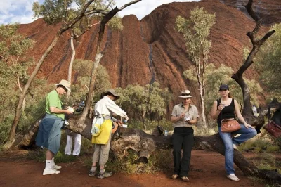 Wake up for a sunrise base walk at uluru, hear anangu stories, and enjoy an outback breakfast picnic. includes hotel pickup and a small group guide.