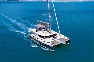 Feel the sea breeze on a santorini catamaran cruise, swim by red & white beach, soak in hot springs, and enjoy a greek bbq with drinks—hotel pickup included.