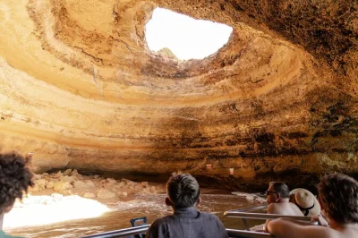 Sail the algarve coast to benagil cave, taste local liquors & sweets, and see highlights like praia da marinha & submarine rock. includes welcome drink & guide.