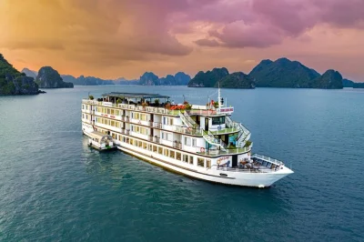 Wake up to limestone peaks, kayak luon cave, and taste bbq on the sundeck. includes pickup from hanoi, all meals, and local guide on a premium ha long bay cruise.