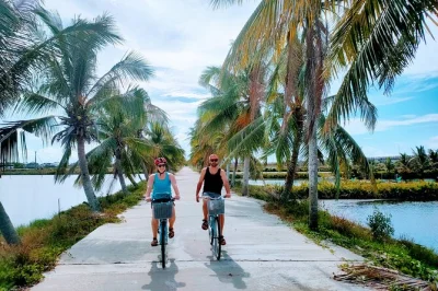 Start your hoi an day cycling past rice fields, meeting farmers at tra que, and rowing a basket boat in the coconut forest. includes pickup, local lunch & guide.
