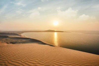 Feel the rush of dune bashing, sip tea by khor al udaid’s inland sea, and watch the desert sky shift colors on this qatar safari—includes pickup from doha.