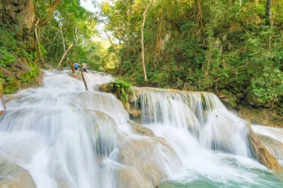 Follow jungle trails from huatulco to copalitilla waterfalls, swim in clear pools, taste handmade tortillas and coffee, with pickup and local guide included.