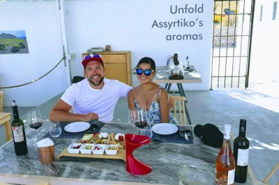 Sample santorini wines at three countryside wineries, stroll volcanic vineyards, and share local cheese with a small group. includes pickup and expert guide.