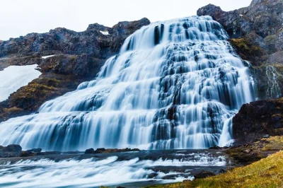 Feel the spray at dynjandi waterfall, meet farm animals, and taste hjónabandssæla cake on this half-day westfjords tour with pickup from isafjordur port.